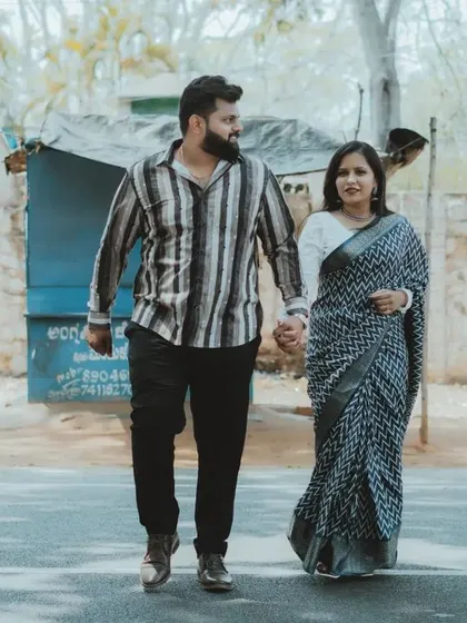 A candid walking shot of a couple holding hands on a quiet street. This lifestyle approach to pre-wedding photography tells a story of your journey together.