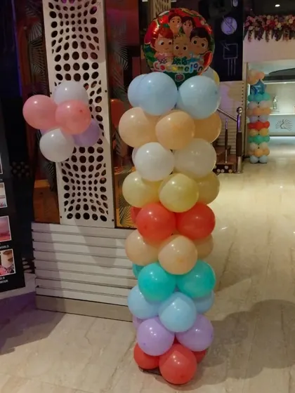 A Cocomelon-themed balloon pillar, perfect for adding a pop of color and character to any corner of the party.