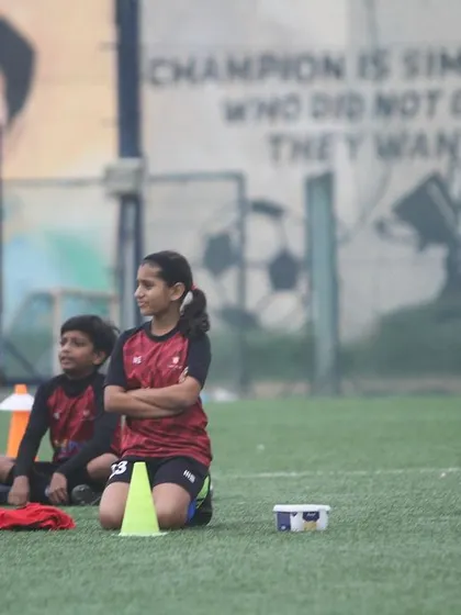 A moment of reflection during our Summer Camp closing ceremony. A young player listens intently, absorbing the lessons from a great season.