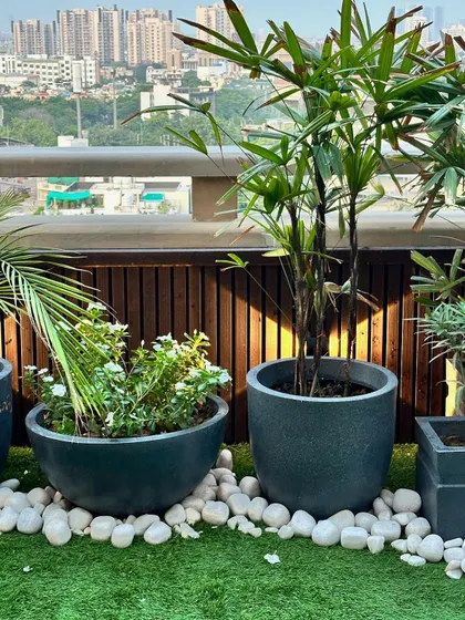 Another detail shot from a balcony project. The combination of dark planters, white pebbles, and artificial turf creates a modern, low-maintenance design that stays beautiful year-round.