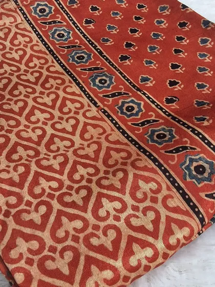 Our fabric collection is where your design ideas begin. This is a beautiful piece of Ajrakh handblock printed modal fabric, with its classic earthy tones and intricate patterns. You can use it to create a custom kurti, a stylish top, or even a beautiful dupatta.