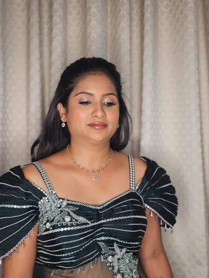 A portrait of Ranjana, showcasing her elegant Sangeet look with soft, glowing makeup and a half-up hairstyle.