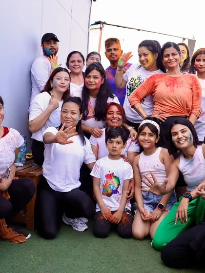 A happy group photo from our Holi celebration on the terrace. Everyone is covered in colors and smiling, capturing the fun and messy joy of the festival.