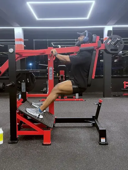 Using the pendulum squat machine to target the quadriceps. This machine allows for a deep squat while providing support for the back.
