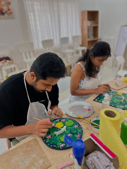 A couple working side-by-side on their Koi Fish paintings. It's a wonderful activity to share with a loved one.