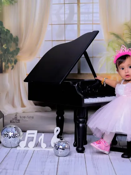 A little princess meets a grand piano in this elegant setup. We combine our 'Mini Musician' theme with a touch of royalty, complete with a beautiful dress and a tiny crown for a magical baby girl photoshoot.