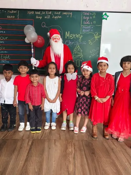 Santa Claus joins a classroom to celebrate with the students, spreading joy and festive spirit.