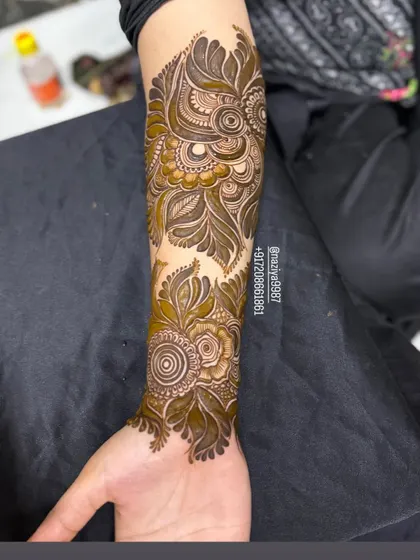 A full arm piece with a mix of floral and paisley elements. The design flows beautifully from the elbow down to the wrist.