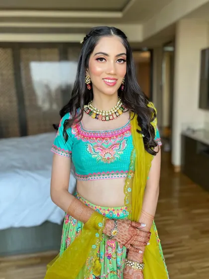 The full look, showing how the soft makeup harmonizes with the bright, multi-colored outfit for a balanced and stunning result.