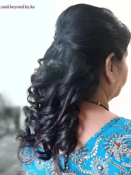 This half-up, half-down style with classic curls is a fantastic and reliable choice for any wedding guest. It's elegant, works with almost any Indian outfit, and is comfortable to wear for long hours.