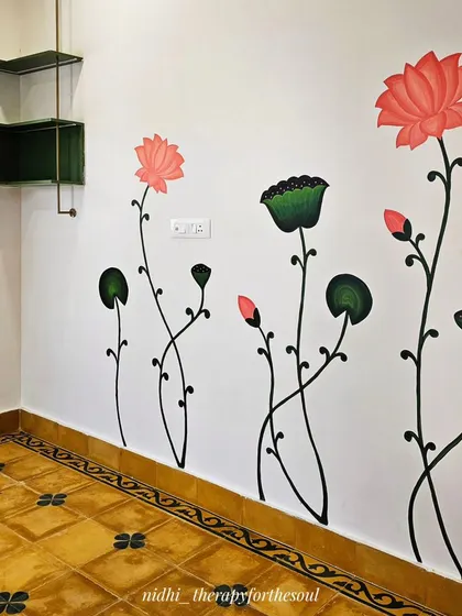 The lotus stems are painted to look as if they are growing up the wall, adding a sense of height and organic movement to this corner of the study.