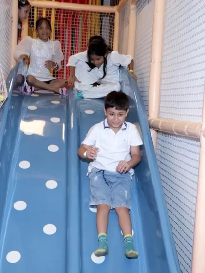 A young boy having a great time coming down our wide, multi-lane slide.