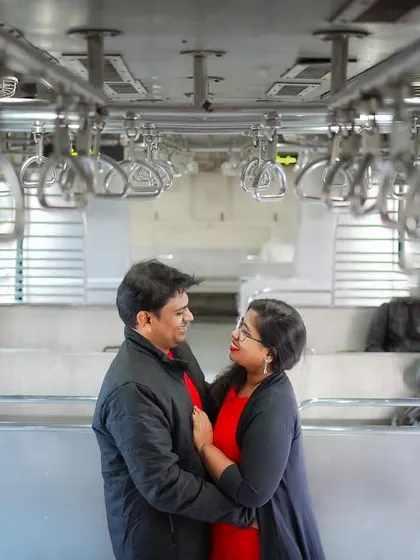 A classic portrait inside a Mumbai local train. The symmetry of the handrails and the authentic environment create a unique backdrop for a modern love story.
