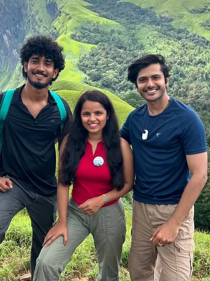 Three friends posing on the green meadows of Netravati. Our treks are a great way to make new friends and create lasting memories.