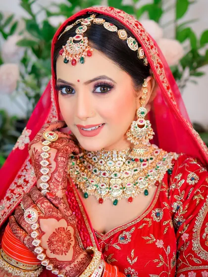 This portrait captures the complete bridal look, including the detailed henna on her hands. I ensure every part of the bridal preparation is honored.