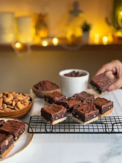 Here's a closer look at the 3-Layer Almond Fudge from my Diwali collection. You can see the distinct layers of shortbread, rich fudge, and smooth chocolate frosting, making it an irresistible treat.