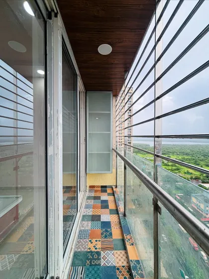 Another view of the balcony, showing the wooden ceiling panel that adds a touch of warmth to the design.