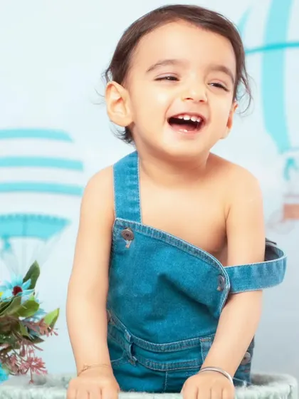 A big, joyful laugh from this little one in our hot air balloon setup.