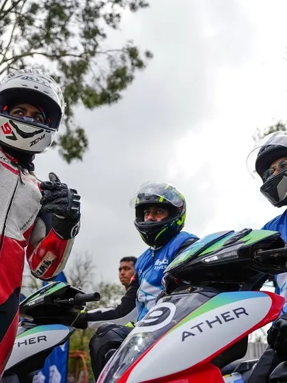 A moment of camaraderie between riders before the start of an EV race. Our events bring together professionals and amateurs who share a passion for motorsport.