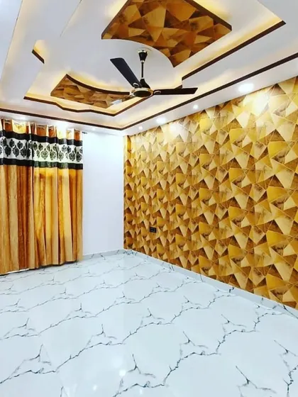 This room uses a gold geometric 3D-effect wallpaper to create a stunning accent wall. It pairs beautifully with the modern PVC ceiling and makes the space feel bright and luxurious.