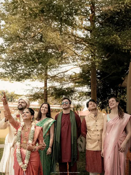 A candid group photo of the wedding party looking up at something with wonder. It's a unique, unposed moment that captures the shared experience of the day.
