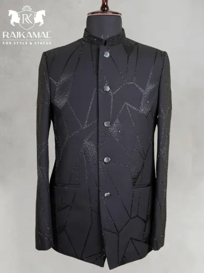 A sleek and modern black Jodhpuri suit. This piece features a geometric pattern created with subtle, shimmering black beadwork for a contemporary and stylish look.