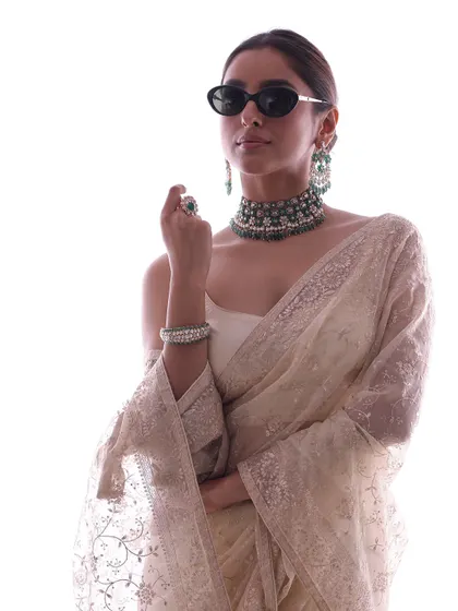 A chic and modern way to style a classic Sabyasachi saree. I added sunglasses and a bold emerald choker to give this traditional outfit a contemporary, high-fashion edge.