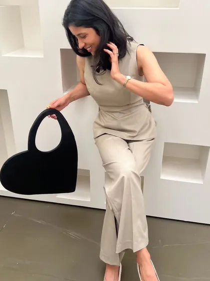 Having some fun with my heart-shaped structured bag. It adds a playful touch to an otherwise serious and powerful monochrome outfit.