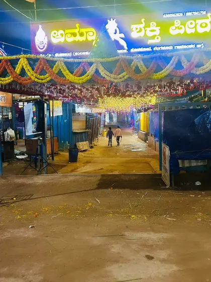 A wide view of the festival grounds, showing the chappra entrance archway leading into the event area.