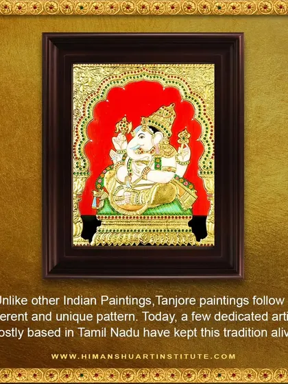 A framed Tanjore painting of Ganesha against a rich red background. These paintings are known for their devotional themes and long-lasting shine.