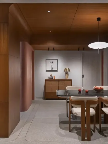 This open-plan living and dining area captures my signature Japandi style, blending warm wood tones on the ceiling with cool terrazzo flooring. The design creates a seamless flow, making it the true heart of the home.
