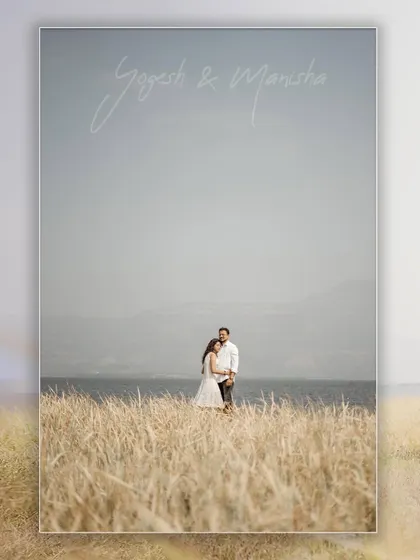 A beautiful landscape portrait with the couple standing in a field of tall grass by the water, perfect for a save-the-date.