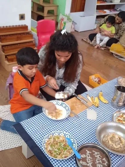 A mother and child work together on a food preparation activity. These moments are precious, strengthening bonds and allowing parents to see Montessori principles in action.