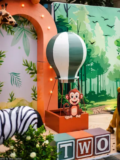 A close-up of the monkey in a hot air balloon prop. This playful and imaginative detail adds a sense of adventure and fun to the jungle theme.