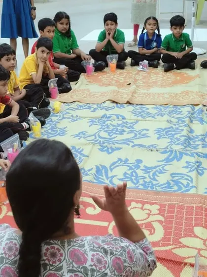 An over-the-shoulder view of an instructor engaging with a group of students. We ensure every child feels included and gets to participate.
