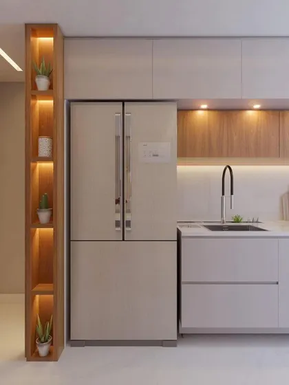 A tall pantry unit with integrated lighting next to the refrigerator, demonstrating our focus on smart storage solutions.