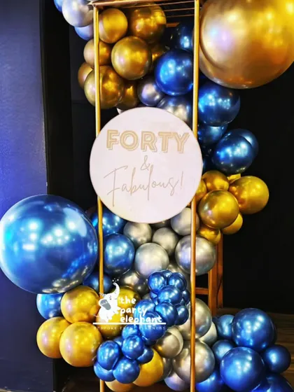 A custom sign reading 'Forty & Fabulous' was incorporated into this balloon installation, adding a fun and personal message to the celebratory decor.