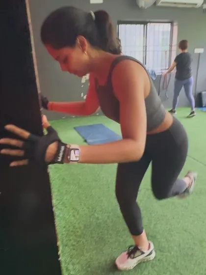 A client performs a single-leg stability exercise against a wall, a great way to improve balance and strengthen the muscles around the hip and knee.
