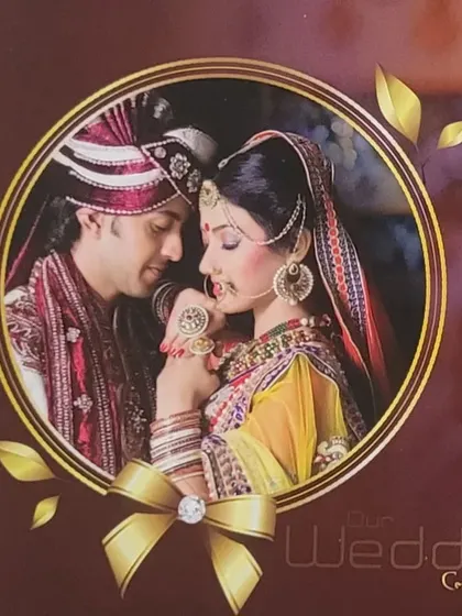 The cover of a wedding album, showcasing a romantic couple portrait within a decorative frame.