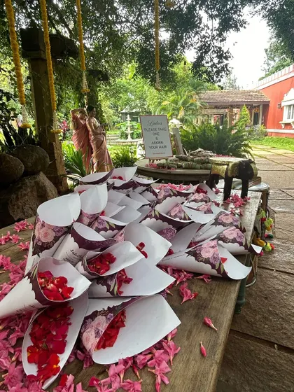 A detail shot of paper cones filled with fresh rose petals for guests to shower the couple with blessings.