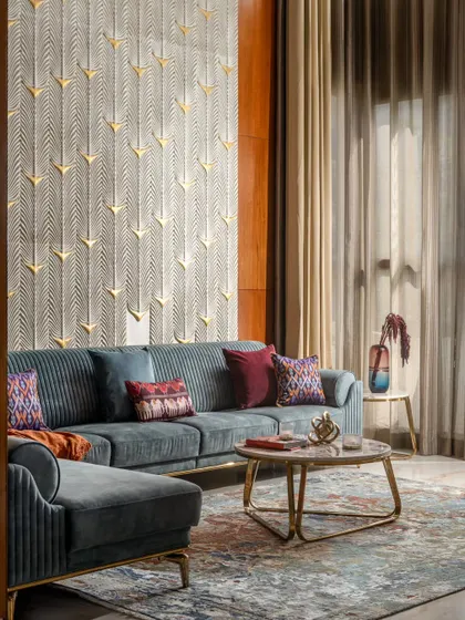 Another view of the living room, showcasing the rich interplay of textures. The detailed carpet, velvet sofa, and the carved stone wall come together to create a space that is both elegant and inviting.