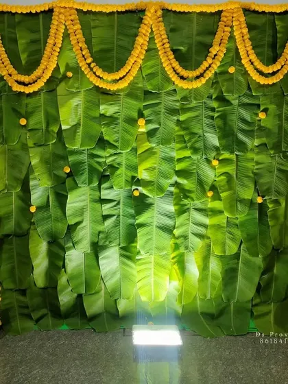 An alternate view of the traditional banana leaf backdrop with marigold garlands.