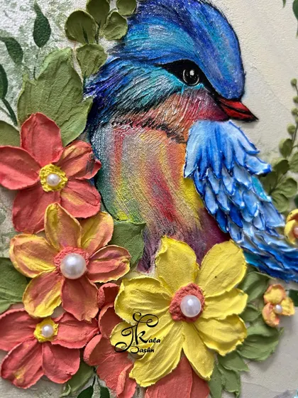 A final close-up of the bird's face and the surrounding sculpted flowers.