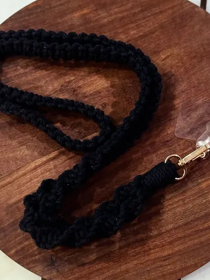 A classic black mobile lanyard. The spiral knot design adds a touch of texture. It comes with a clear patch to attach to your phone case.