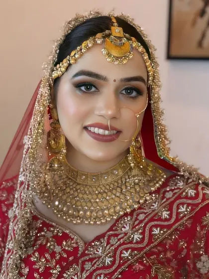 A close-up portrait of a smiling bride. Her makeup features a soft brown smokey eye and a matching lip color, perfect for a classic look.