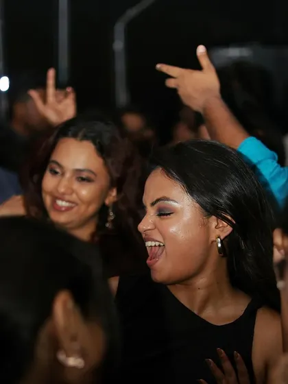 Another shot of the women enjoying the party. The vibe is relaxed, fun, and full of laughter.