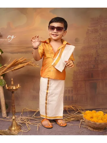 Adding a little bit of swag with sunglasses. This little boy is rocking his traditional look for his birthday shoot.