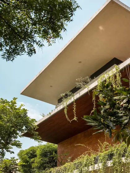 A low-angle view of the cantilevered roof, a key architectural feature that provides shade and defines the outdoor spaces.