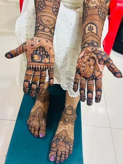 A complete bridal mehendi set, showing how I coordinate designs across both hands and feet. This set includes intricate patterns, traditional motifs like swans, and a divine Radha Krishna portrait, telling a complete story for the bride's big day.