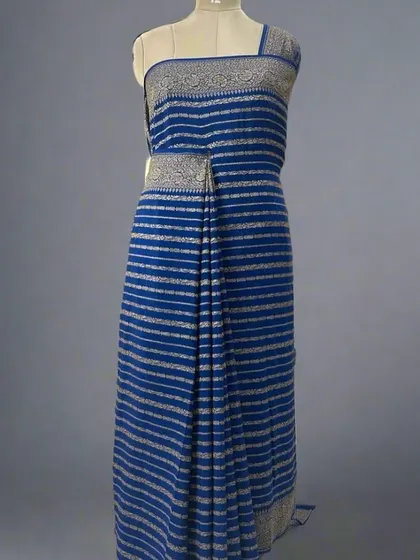 A mannequin draped in a blue pure Banaras crepe saree with silver stripes.